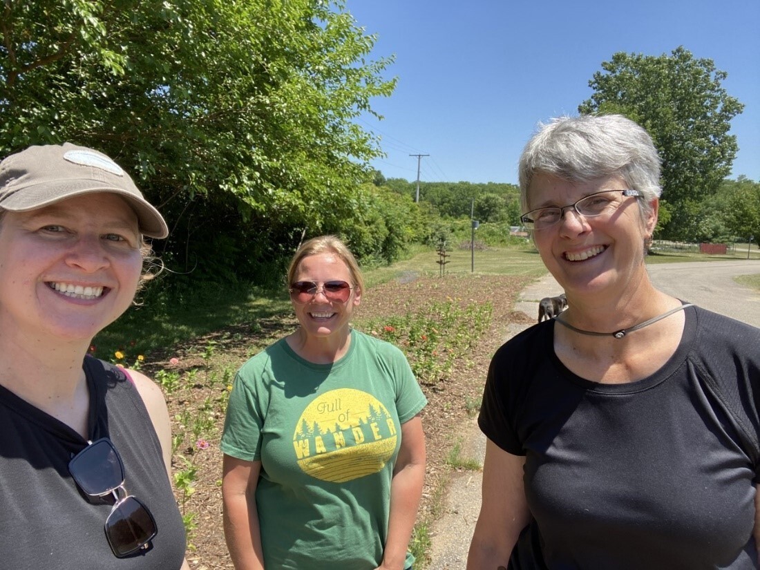 3 women standing on the side of the road