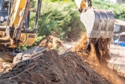 Backhoe digging a trench